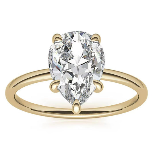 Pear-cut clear-stone solitaire ring with a polished 10K gold band on a white background.