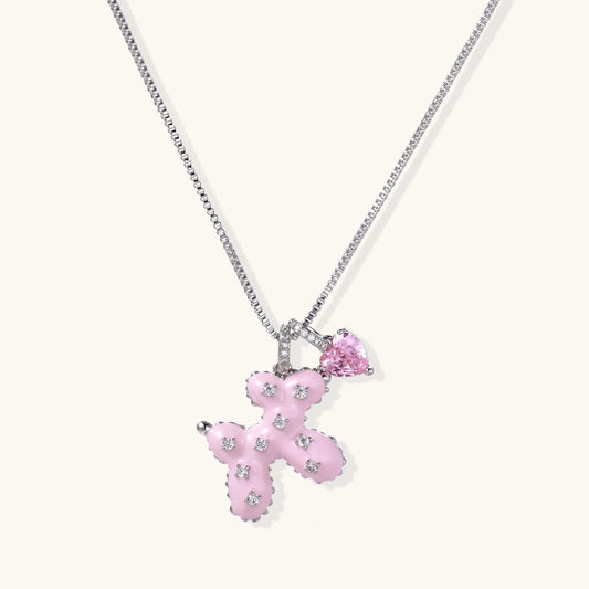 Pink enamel bear and heart necklace with zirconia details on a silver-tone chain.